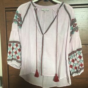 Light purple top with embroidery.